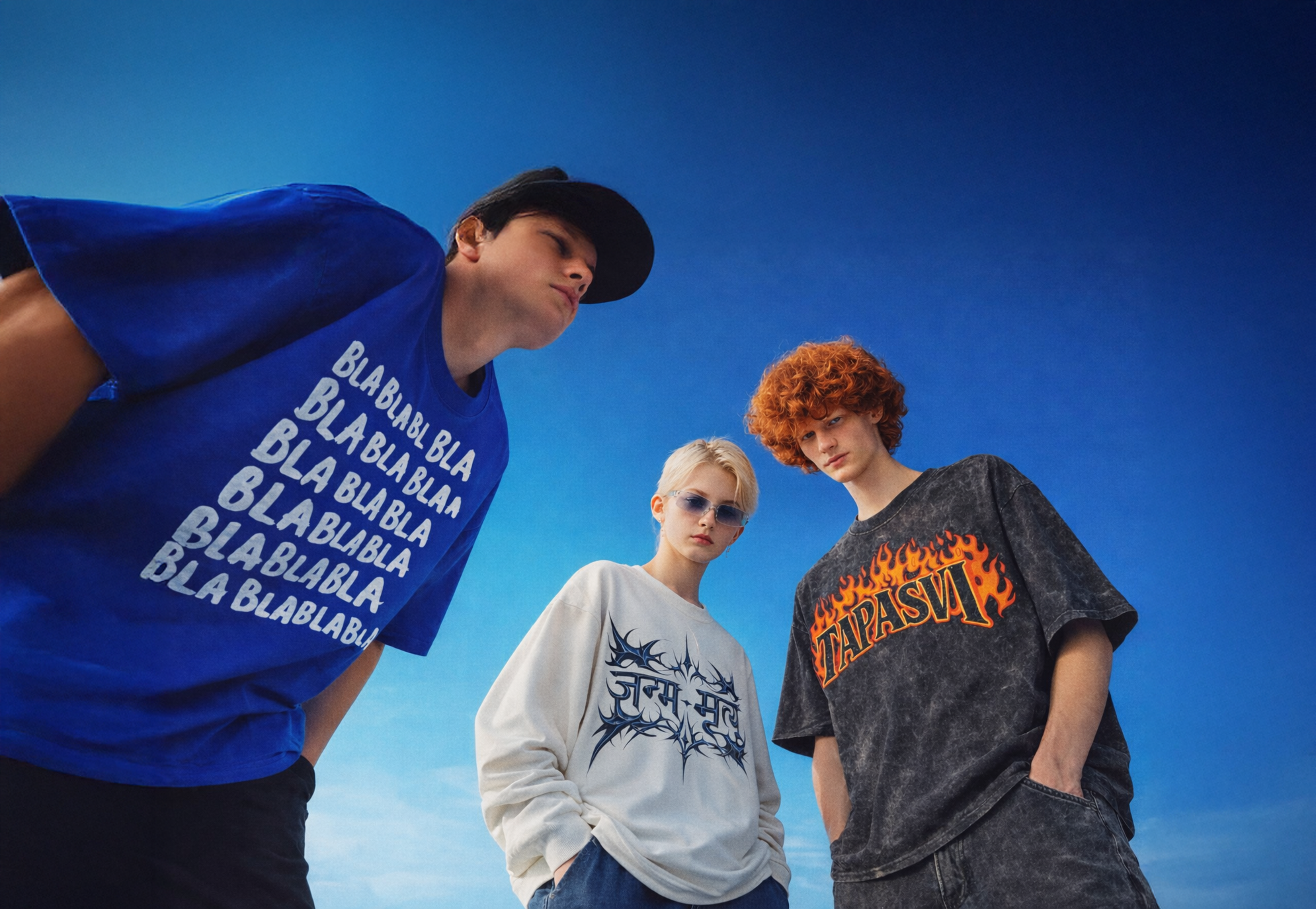 Three people wearing different t-shirts against a blue sky